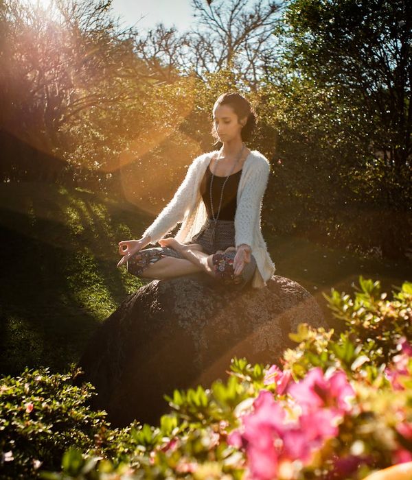 Woman in a calm yoga pose, embodying tranquility and balance.